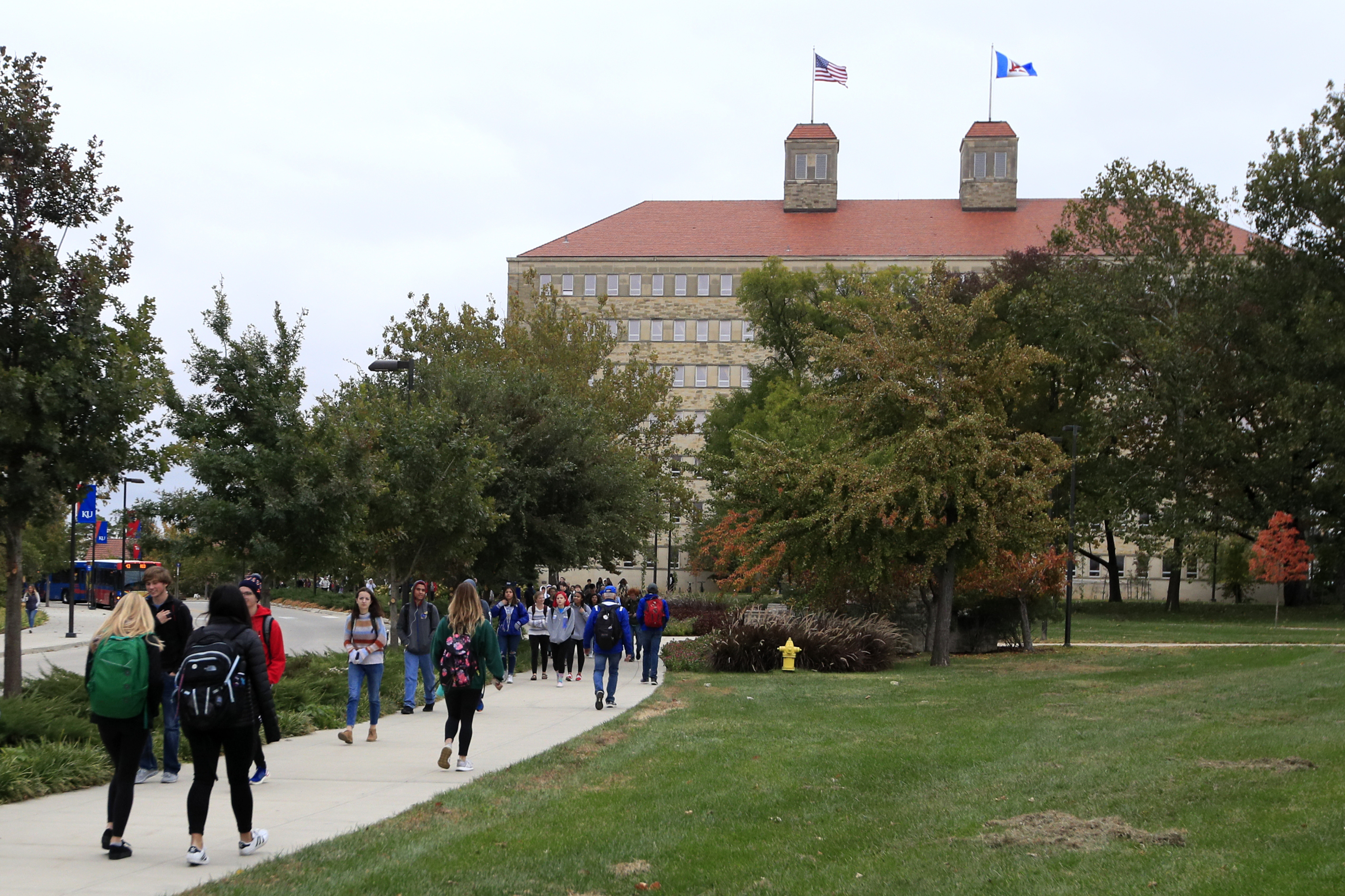 In this Oct. 24, 2019, file photo students walks in front of Fraser Hall on the University of Kansas campus in Lawrence, Kan. (AP Photo/Orlin Wagner, File)